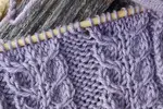 The claw pattern cable is knitted over 9 stitches and 4 rows.  This is a simple and effective cable stitch that can be done with or without a cable needle.