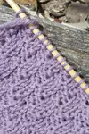 The Check Stitch knitting stitch pattern is another fairly simple stitch pattern that is suitable for beginners.  It uses a basic 2x2 rib stitch that alternates between knit and purl every four rows resulting in 'checks' or blocks of broken columns.